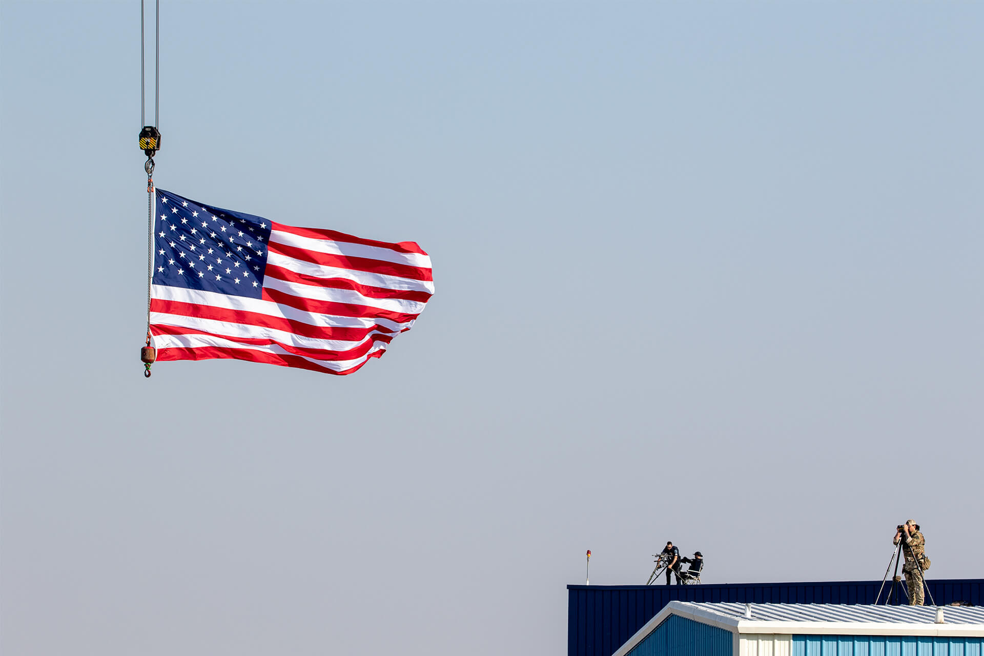 An American flag waves overhead whilst the sheriff's department keeps an eye out for danger; dominating sloped roofs.
