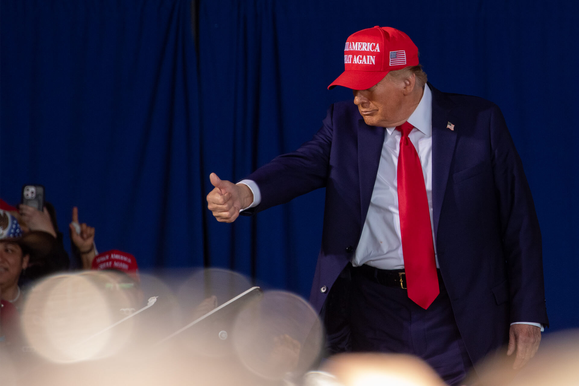 Trump greets specific fans with a thumbs-up.