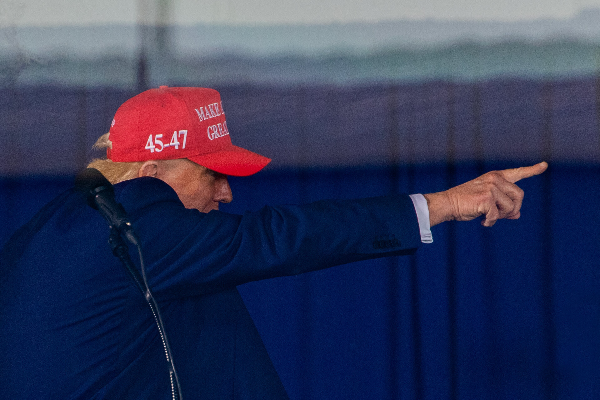 Donald Trump pointing, greeting specific fans.