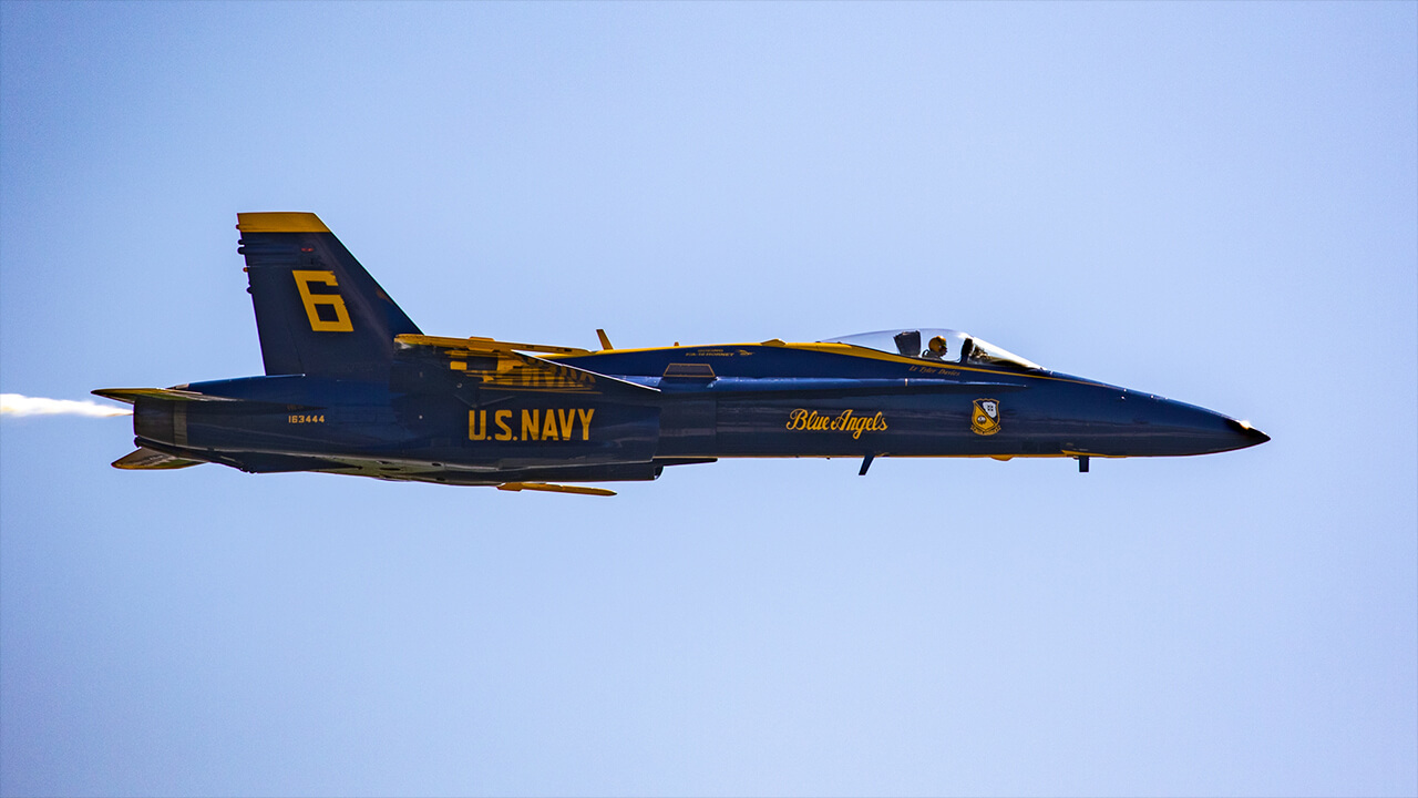 Jolting the crowds to their feet, Navy Lt. Tyler Davies flying Blue Angel No. 6 does an unscheduled good morning flyby at AirVenture.