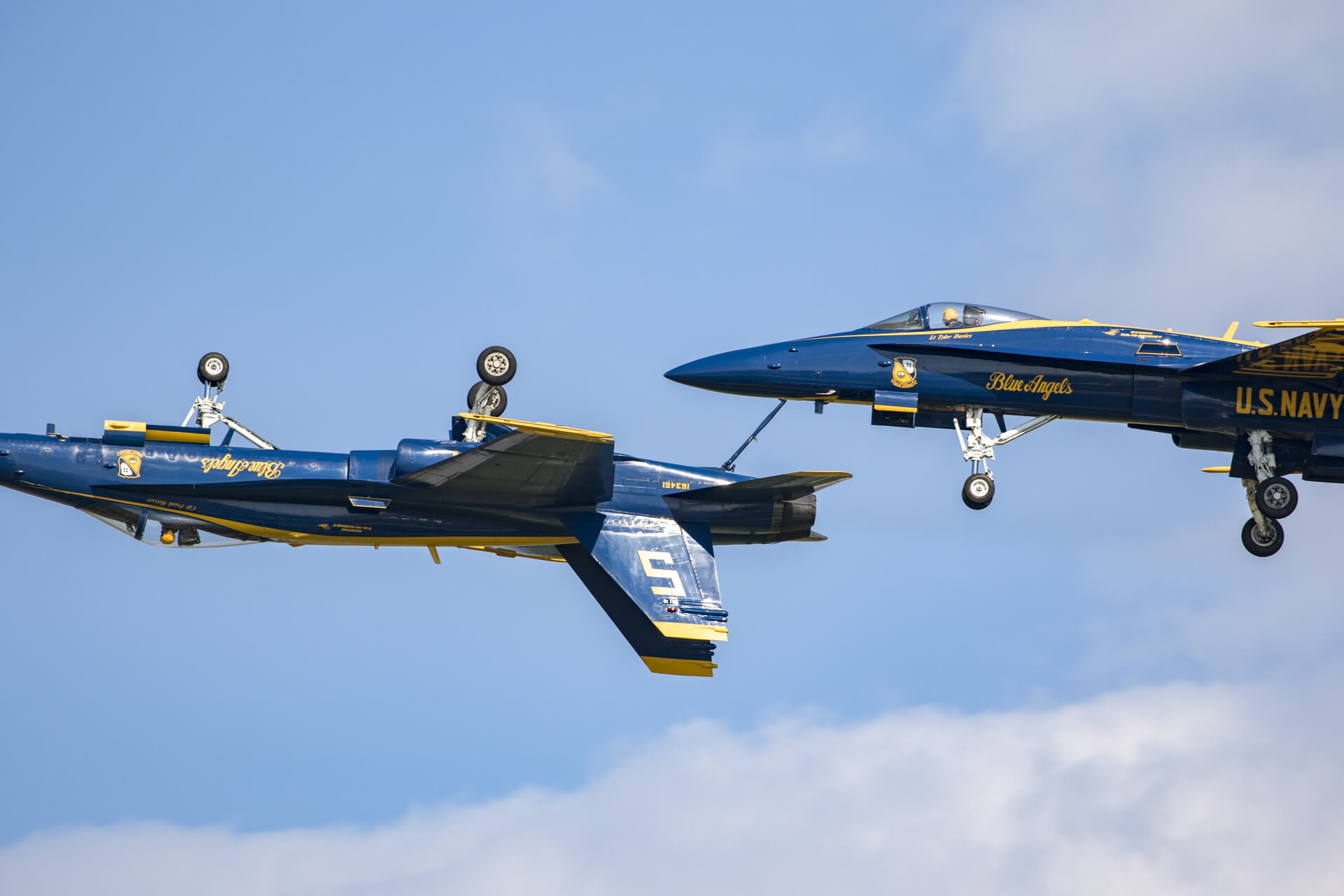 Blue Angels showing off their precision while inspecting each other’s tailhooks in flight.