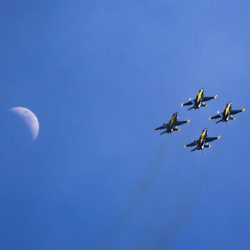 Blue Angel squadron flying in formation with the Death Star (moon) in frame.