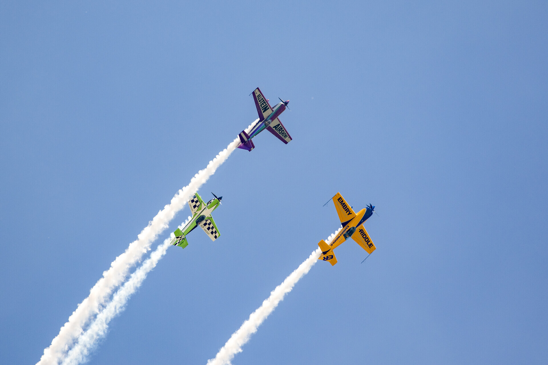 Michael Goulian (green), Matt Chapman (yellow), and Bill Stein (purple) flying together at AirVenture 2017.
