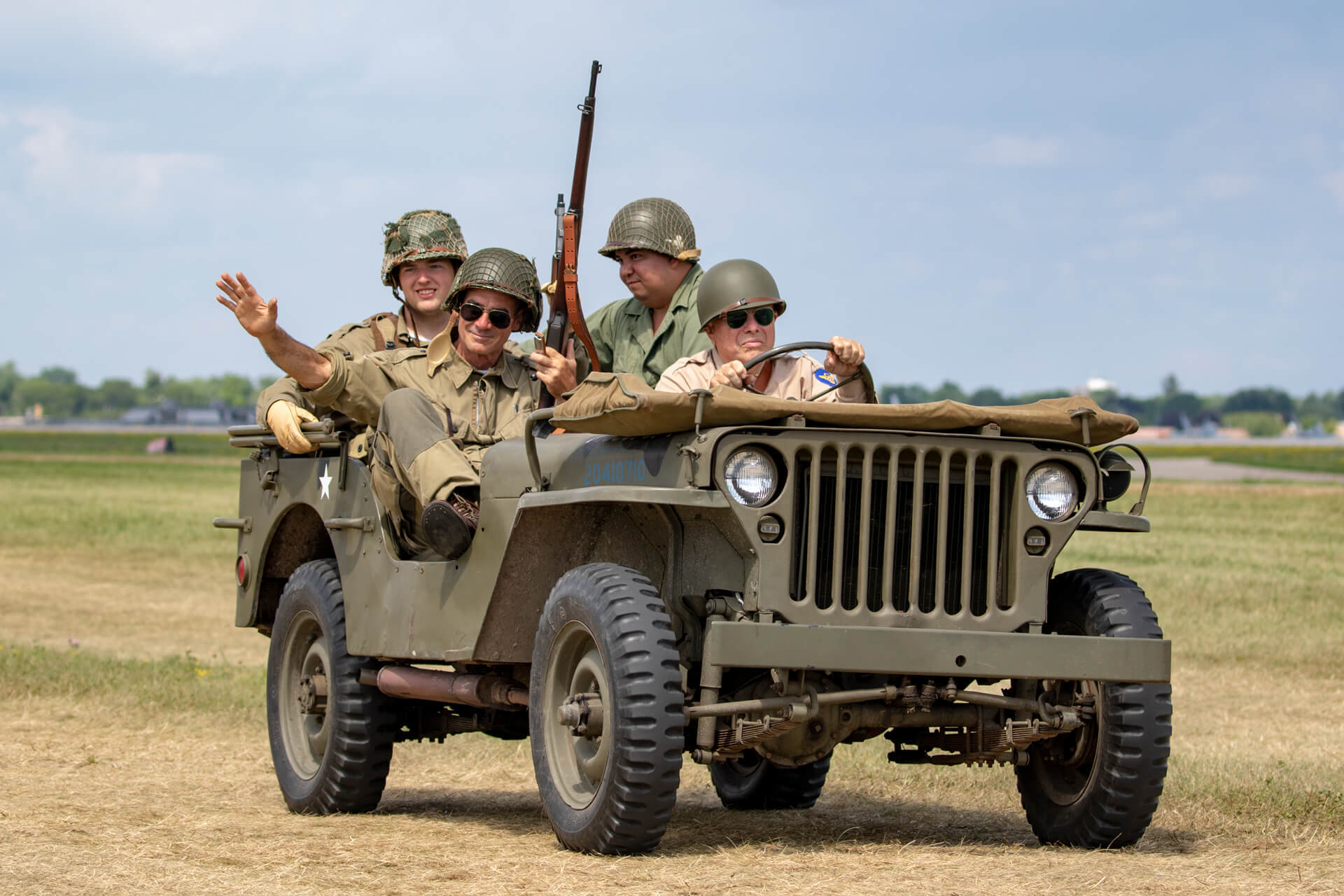 Reenactors from Warbirds of America driving a World War II era jeep before the big show.
