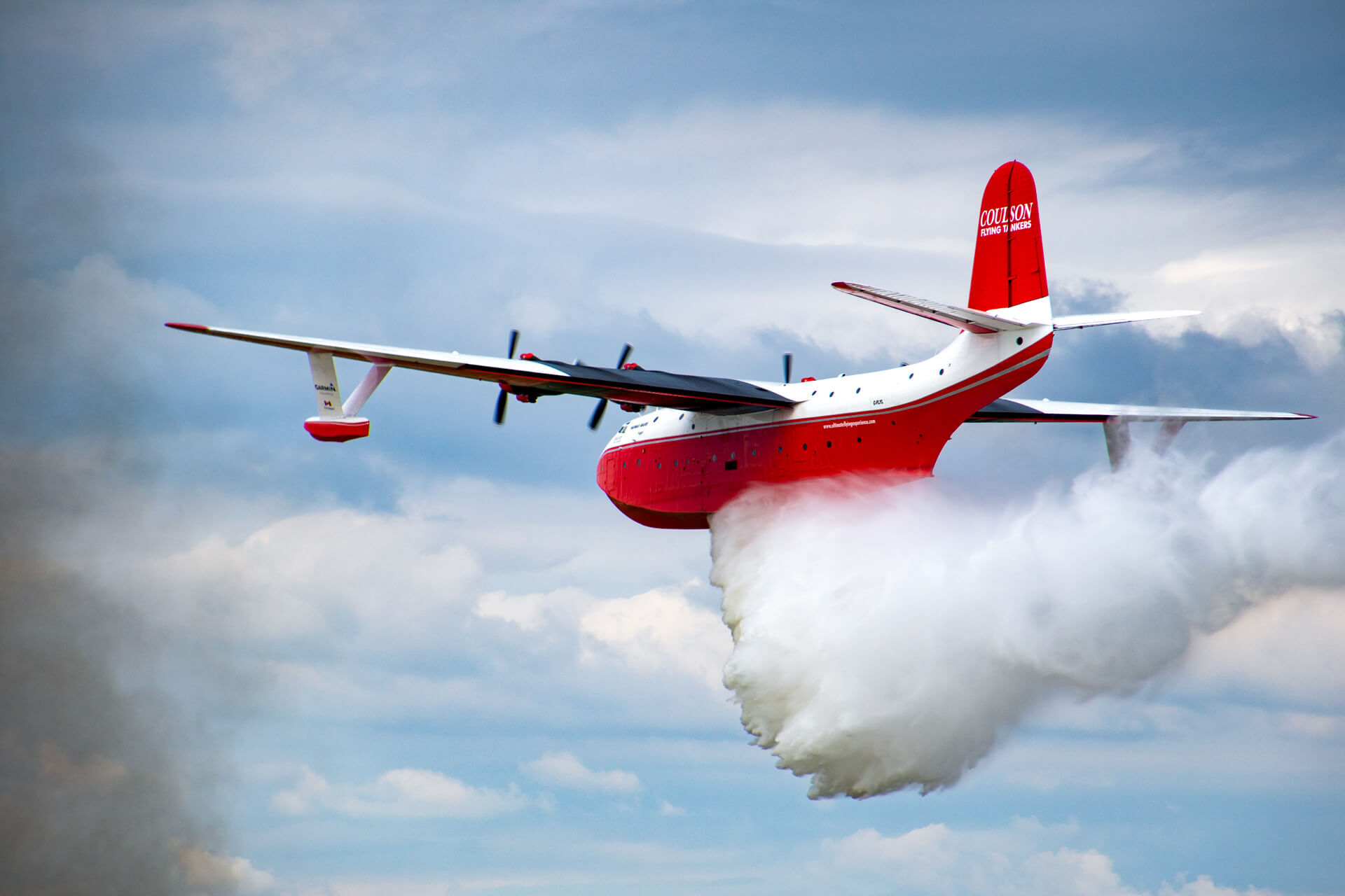 What 7,200 gallons of water leaving the back of a 70 year old plane looks like.