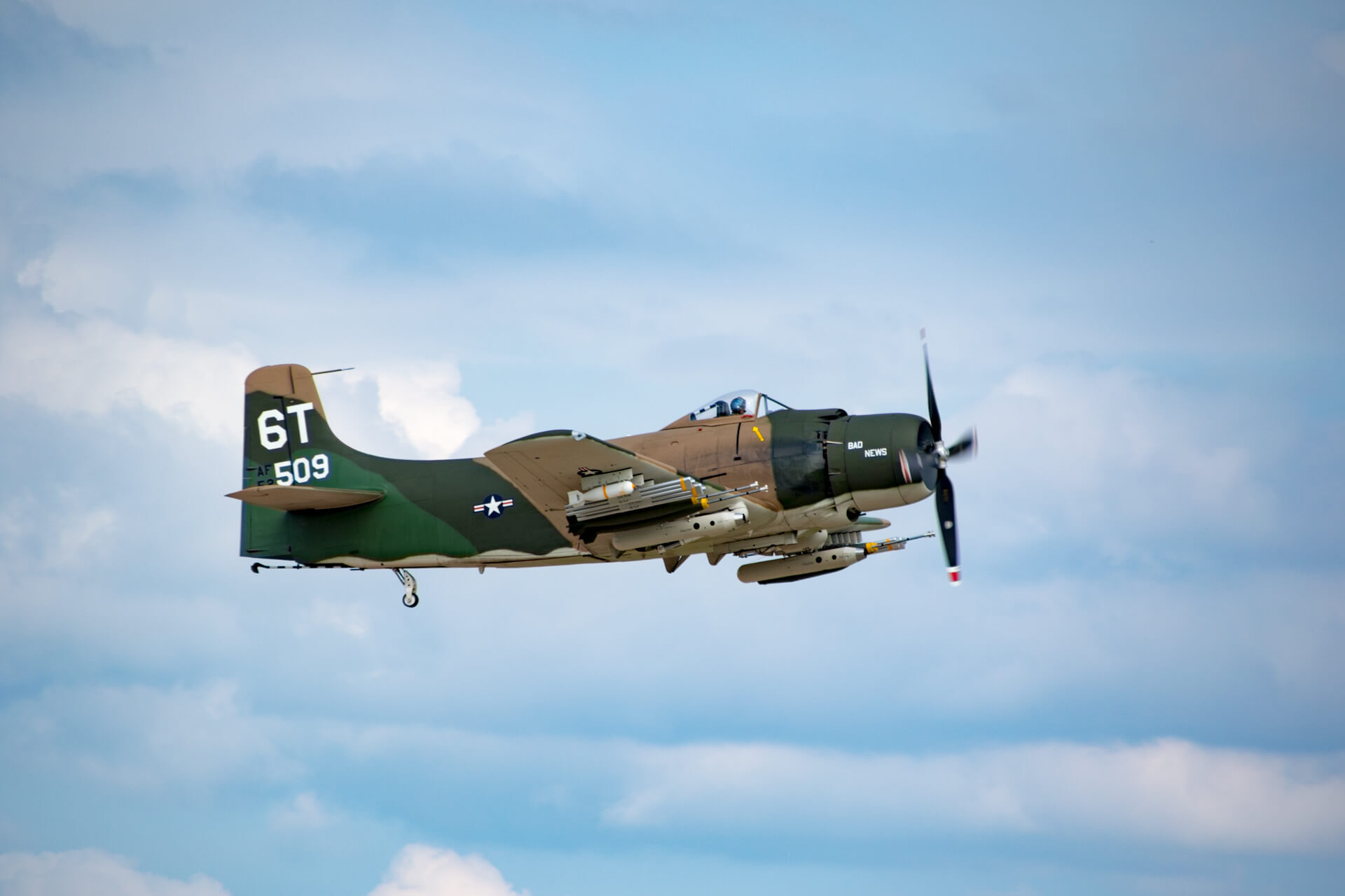 A Douglas A-1 Skyraider patrols the sky over Oshkosh.