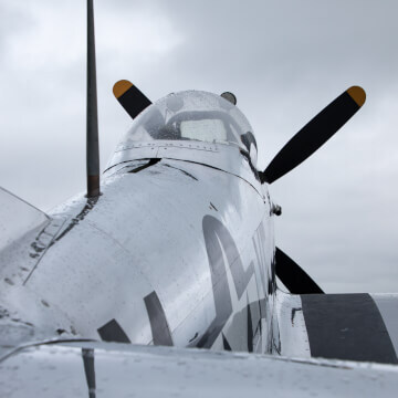 Water droplets collect from a morning sprinkle onto a beautiful F4U Corsair.