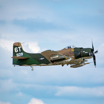 A Douglas A-1 Skyraider patrols the sky over Oshkosh.