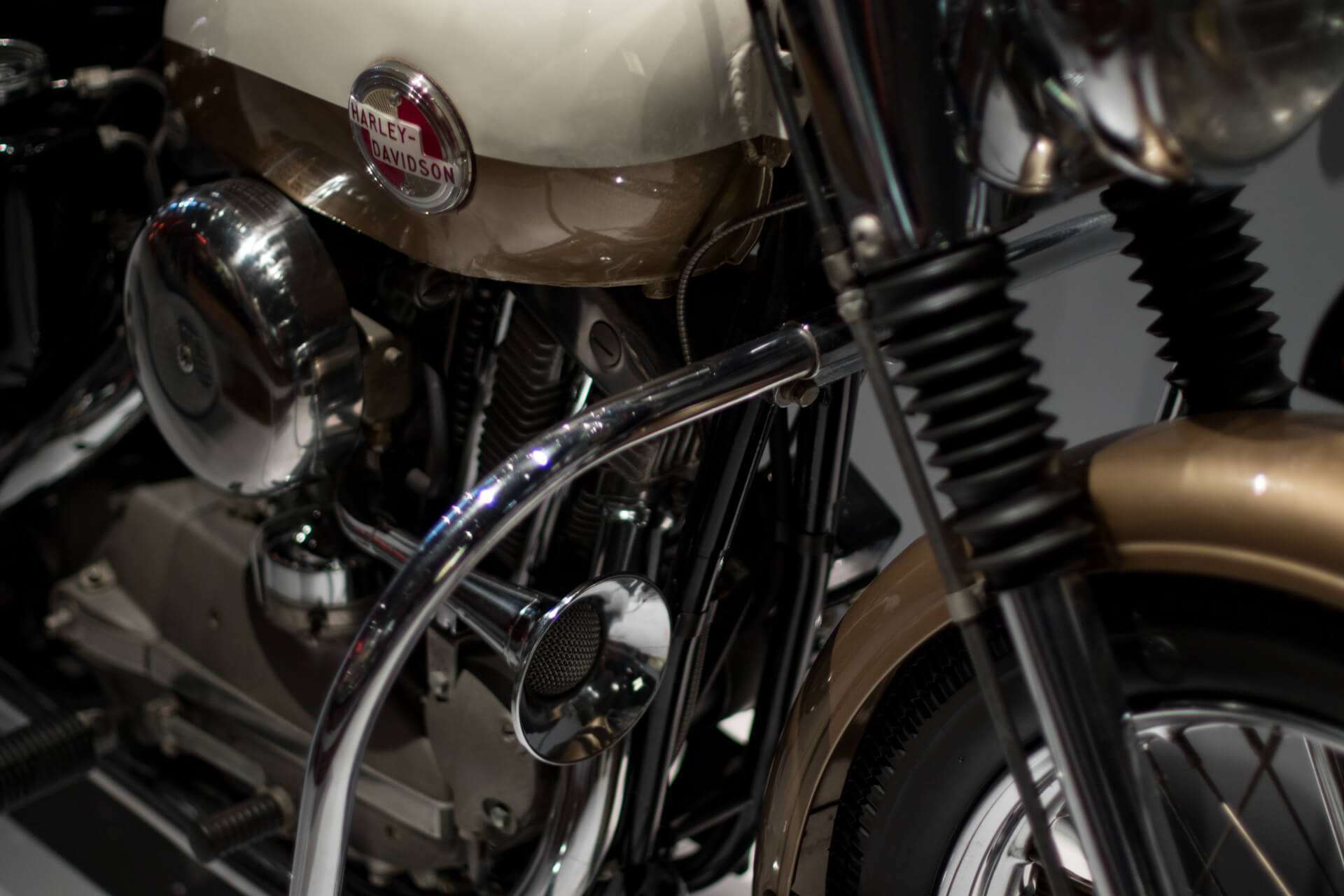 The 1957 Harley XL Sportster showing off its nugget gold and birch white paint.