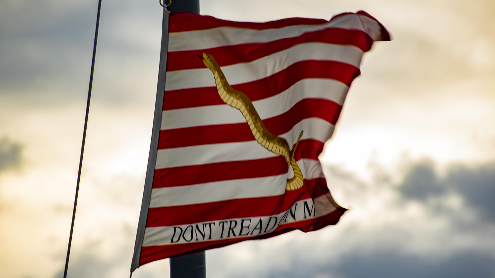 The First Navy Jack whipping in the harsh November winds aboard the USS Milwaukee.